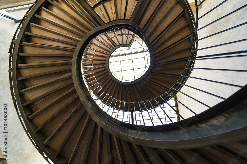 Fototapeta premium Chonburi, Thailand - May, 26, 2024 : Journey to the Light: The Spiral Staircase at Chonburi, Thailand.