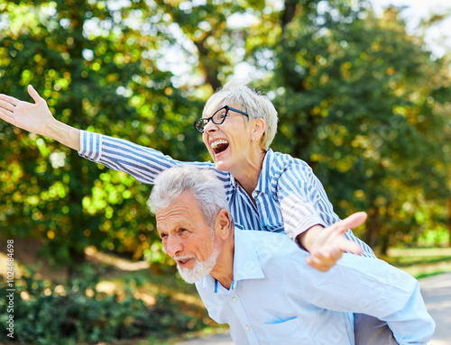 woman man outdoor senior couple happy lifestyle retirement together smiling love fun elderly active vitality nature mature portrait piggyback game photo