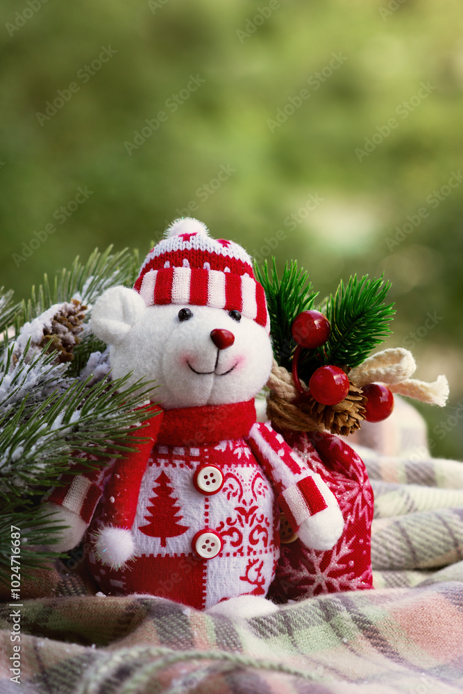 Winter postcard. Teddy bear on the background of a fir branch. Christmas and New Year mood. Winter postcard. Teddy bear on the background of a fir branch. Christmas and New Year mood.