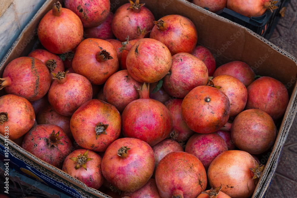 A background of fresh pomegranates in a box in perfect details. A background of fresh pomegranates in a box in perfect details.
