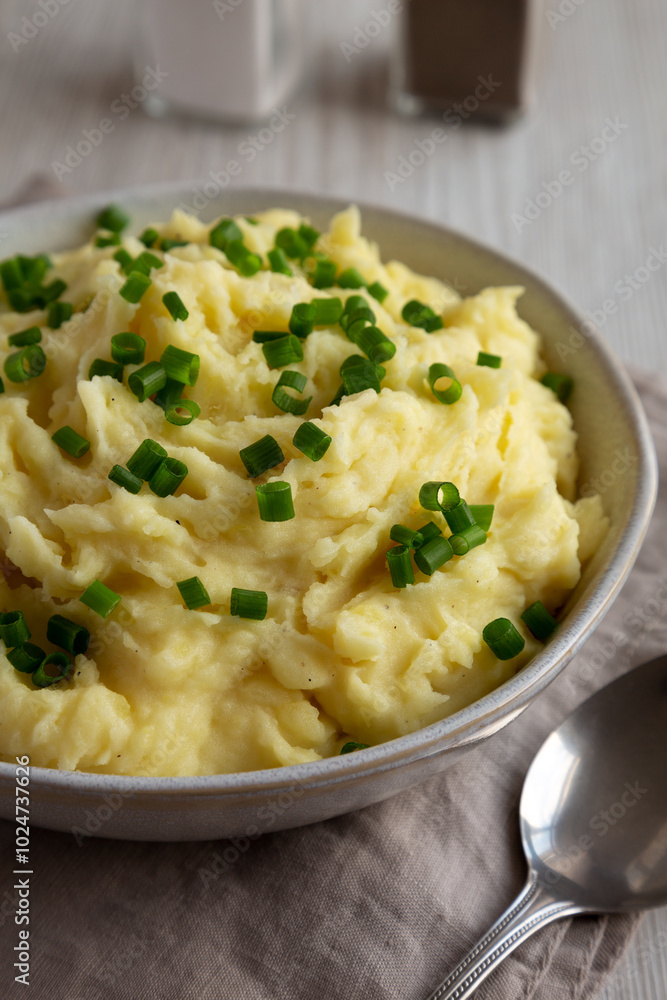 Homemade Chive and Garlic Mashed Potatoes in a Bowl, side view. Close-up. Homemade Chive and Garlic Mashed Potatoes in a Bowl, side view. Close-up.