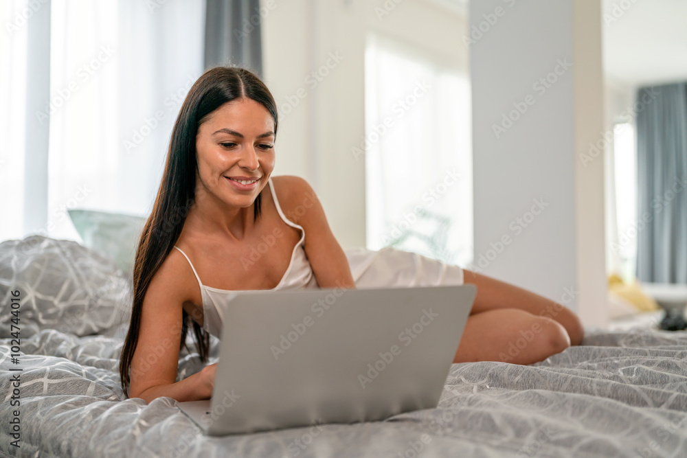 Young beautiful woman using computer to check social media, working or read emails. Young beautiful woman using computer to check social media, working or read emails.