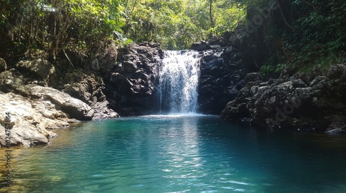 Tranquil waterfall cascading into a crystal-clear pool surrounded by lush greenery in a serene natural setting