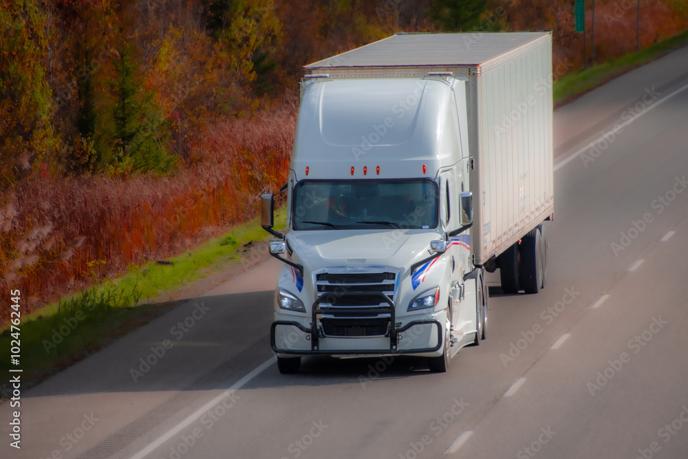 Heavy truck on a Canadian highway in the fall in Quebec Heavy truck on a Canadian highway in the fall in Quebec