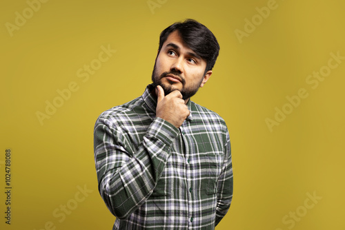 man with hand on chin, thoughtful and looking up