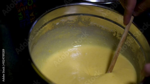 man cooking at home top view spreading white cream on the puff pastry layers to prepare a Napoleon cake. cooking process step by step. Cooking With Love For Family Male Hairy Hands