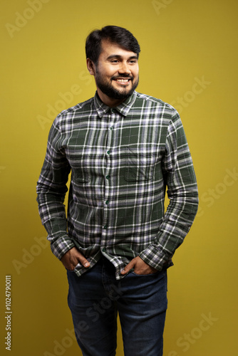 man smiling with hands in pocket and looking to the side