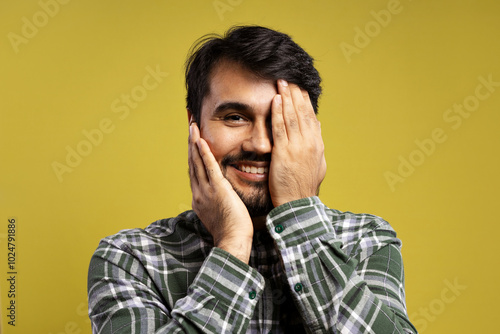 man smiling with hands touching face