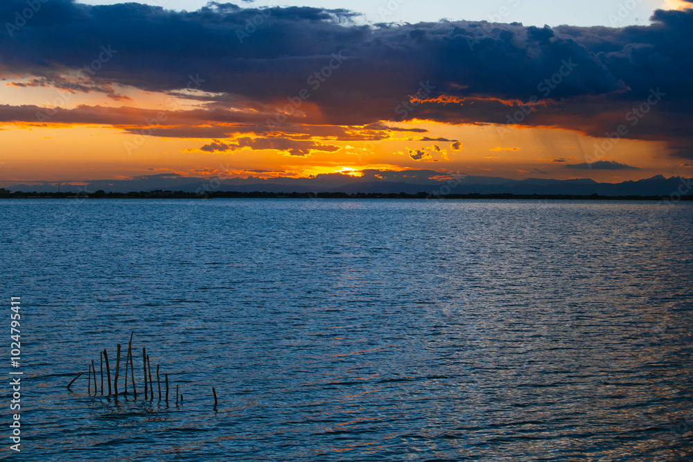 Cloudy colorful contrast sunset. View from the coast towards sea. Italy. Cloudy colorful contrast sunset. View from the coast towards sea. Italy.