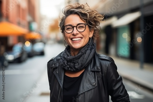 Portrait of a beautiful young woman with glasses and a scarf smiling