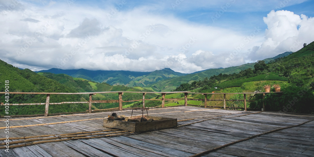 Naklejka premium Landscape image of mountain view from wooden balcony with bonfire