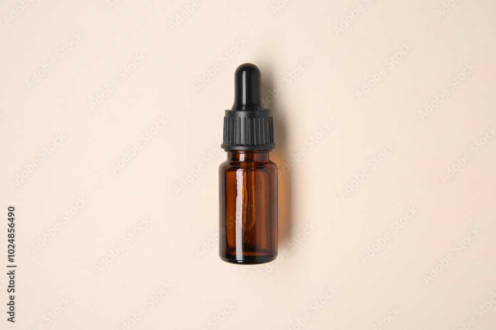 Essential oils in bottle on beige background, top view Essential oils in bottle on beige background, top view