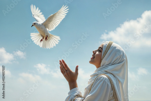 Muslim girl releases a white dove of peace into the sky. photo