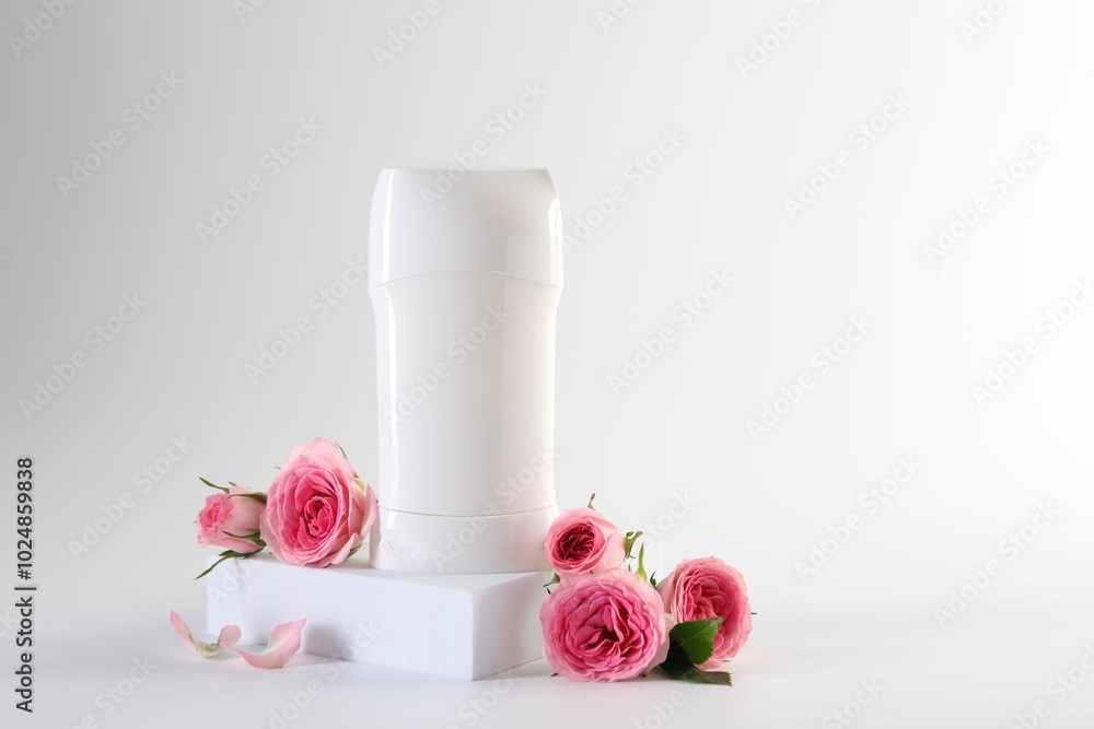 Solid deodorant and beautiful rose flowers on white background Solid deodorant and beautiful rose flowers on white background