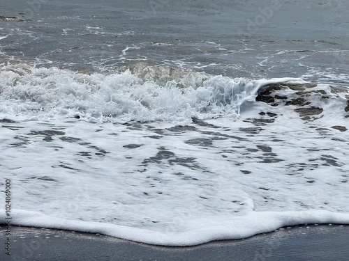 close-up of a wave with its foam in a rough sea
 photo