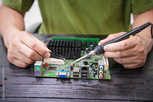 Engineer, a precise computer motherboard repair technician, uses a screwdriver to change parts, focuses on technology maintenance, repairs electronic devices, and supports ideas.