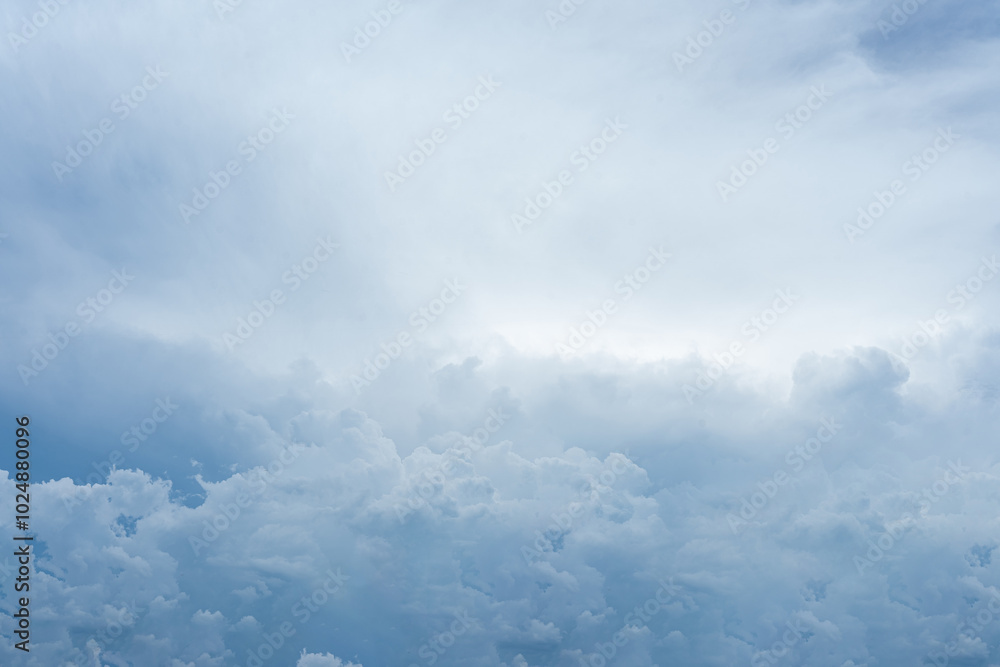 Dramatic cloudscape with fluffy white clouds against a deep blue sky, illuminated by soft sunlight Dramatic cloudscape with fluffy white clouds against a deep blue sky, illuminated by soft sunlight