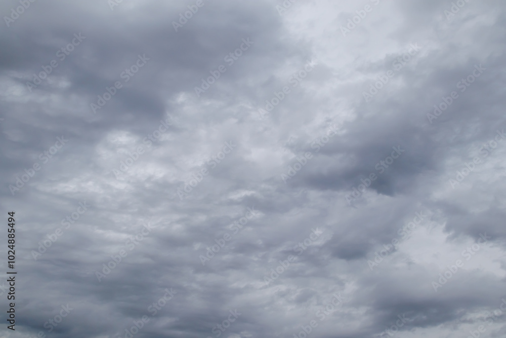 Gray rain clouds loaded with rain in the sky. Overcast sky with dark clouds. Dark sky before a thunderstorm. Gray rain clouds loaded with rain in the sky. Overcast sky with dark clouds. Dark sky before a thunderstorm.