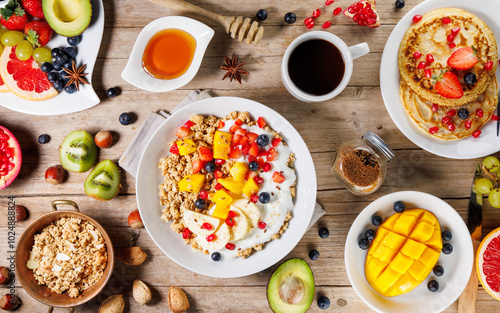 healthy breakfast table with coffee, pancakes, fruits and cereals