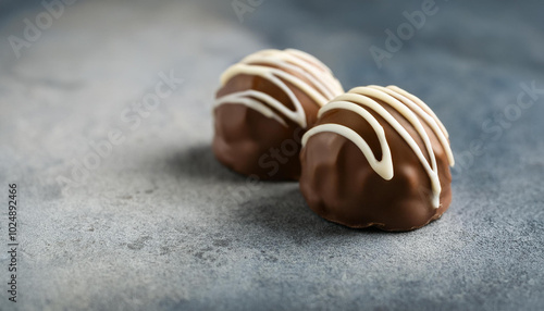 Luxurious truffle, chocolate candy on gray cement table. Tasty sweets. Delicious treat.