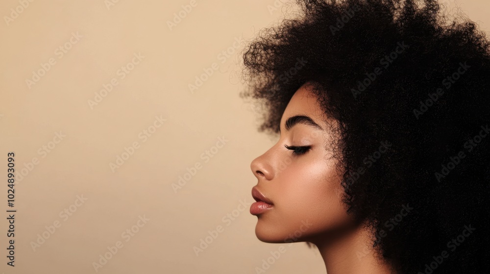 Profile of a young woman with natural hair, side view against a plain background, minimalistic portrait. Profile of a young woman with natural hair, side view against a plain background, minimalistic portrait.
