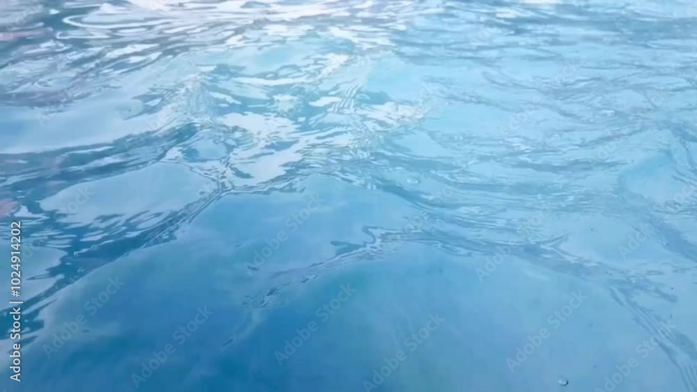 Clean pool water surface with light sparkles in slow motion Clean pool water surface with light sparkles in slow motion