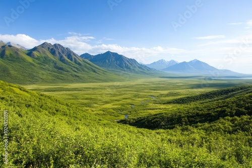 A serene landscape featuring mountains and lush green valleys under a clear blue sky.