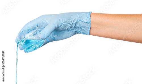 Hand in medical gloves pouring blue liquid from a flask on an empty background. Laboratory experiments, scientific research, healthcare applications.