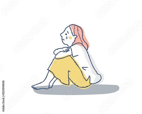 膝を抱えて泣いている女性