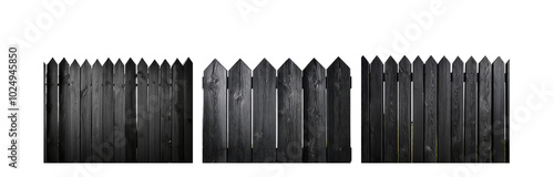 A black wooden fence with pointed tops against a white background.