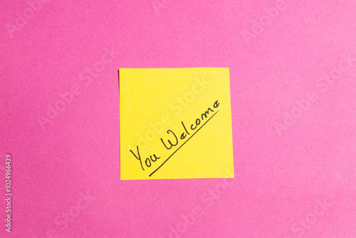 A yellow sticky note with the word "welcome" written on it