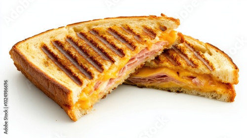 Crispy panini melt filled with cheese and ham, cut open to reveal its layers, isolated on a clean white background with distinct grill marks