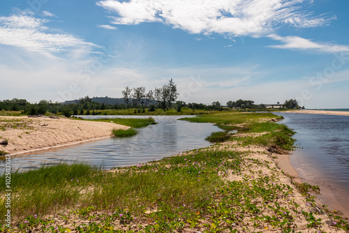 River Song Tranh flowing into the sea on Phu Quoc island, Vietnam, South East Asia. Relaxing getaway tropical island. Enjoyment of natural beauty in tranquil atmosphere. Sand beach covered by greenery