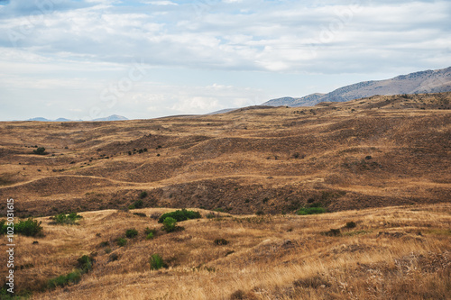 Majestic mountains under a blue sky filled with clouds, showcasing natural beauty and rugged terrain