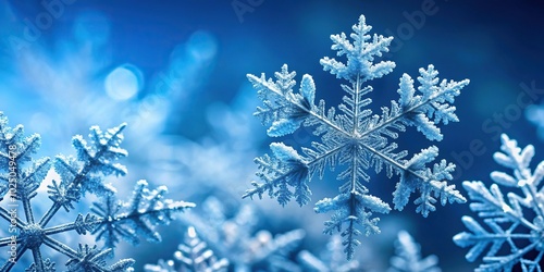 Winter themed stock photo featuring frosty snowflakes and ice crystals on a blue background photo