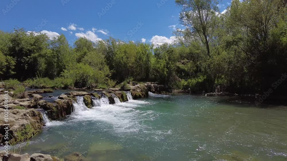 Spring water flowing through green trees in spring. River, waterfall, Van, Turkey. Spring water flowing through green trees in spring. River, waterfall, Van, Turkey.