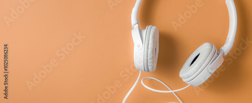 Banner with headphones on orange background and space for text on the right