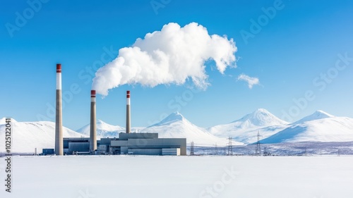A scenic view of a power plant emitting steam, surrounded by snow-covered mountains and a clear blue sky.