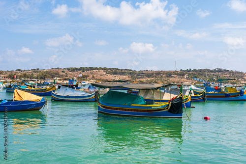 View of Marsaxlokk harbour with traditional colourful fishing boats in Malta