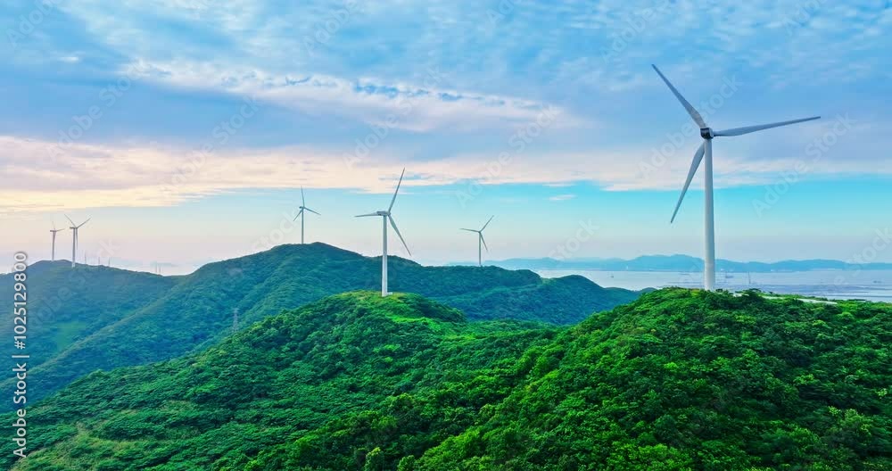 Aerial shot of wind turbines and mountain natural scenery Aerial shot of wind turbines and mountain natural scenery