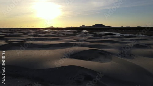 Wallpaper Mural Aerial drone footage of white sand desert dunes with mountains in the background at sunset Torontodigital.ca