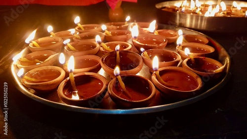 Oil lamps lit on colorful rangoli during diwali celebration, Rangoli with diyas. Diwali is a festival of lights celebrations by Hindus , Jains, Sikhs and some Buddhists photo