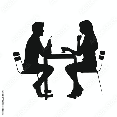 A young Caucasian man and woman sitting at a table, engaged in conversation