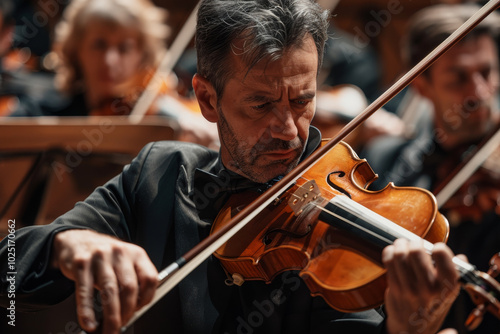 A man is playing a violin in front of a crowd