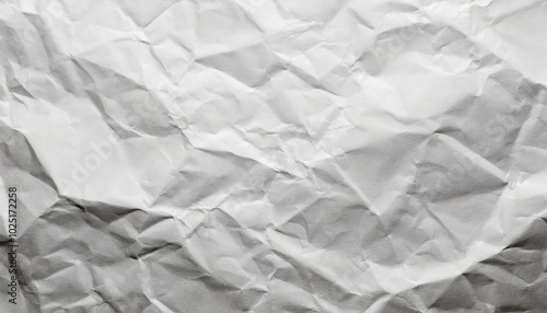 Crumpled white paper texture with subtle shadows showcasing its intricate surface details