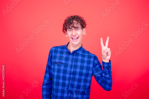 Young attractive guy and different emotions. Red background.