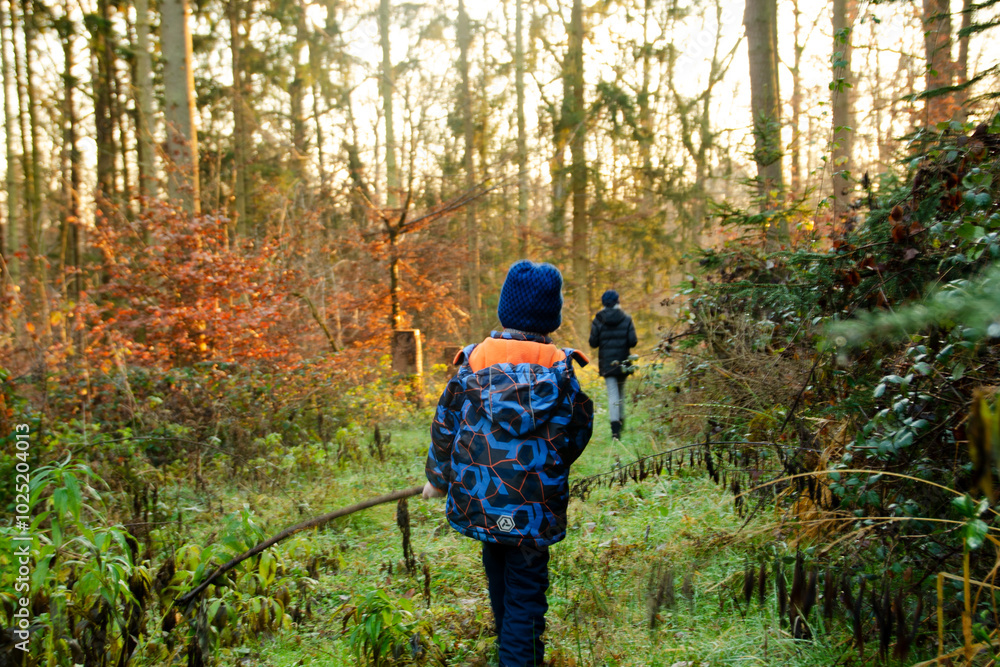 Naklejka premium children walking in the forest