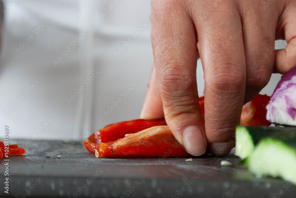 Close-up of a woman's hands cutting vegetables with a knife on a cutting board. Home cooking concept, gastronomy, veganism. Close-up of a woman's hands cutting vegetables with a knife on a cutting board. Home cooking concept, gastronomy, veganism.