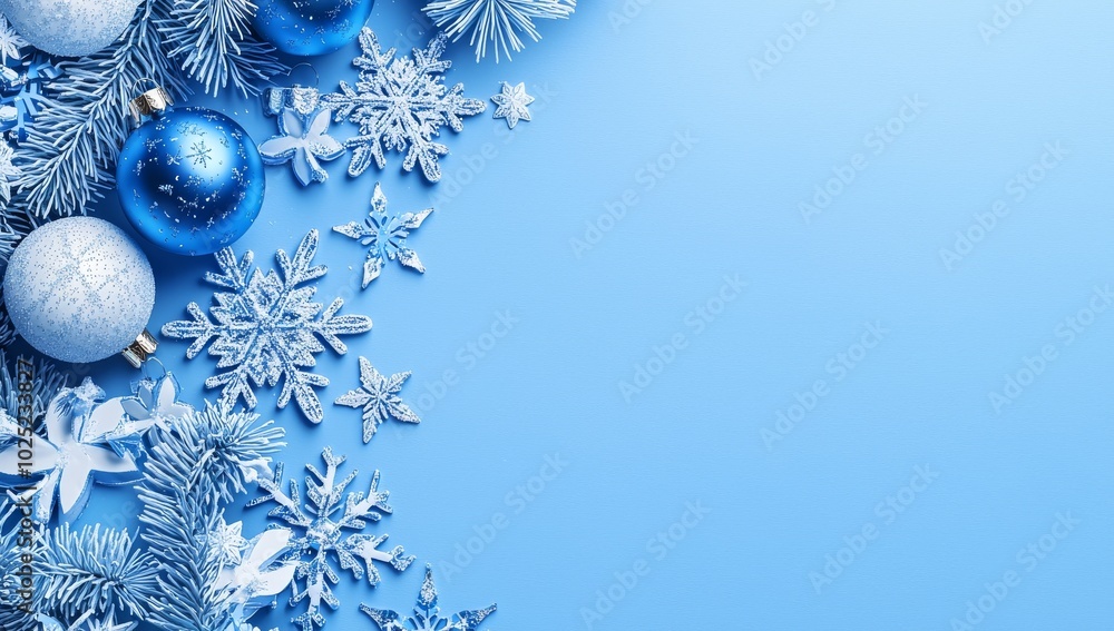 A snowflake and ball background with a blue Christmas theme A snowflake and ball background with a blue Christmas theme