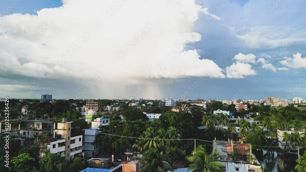 An aerial view capturing a vibrant rainbow arching over the city, as the scene moves forward. The colorful arc contrasts beautifully with the urban landscape An aerial view capturing a vibrant rainbow arching over the city, as the scene moves forward. The colorful arc contrasts beautifully with the urban landscape